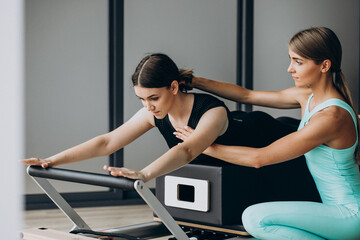 Woman training pilates on the reformer