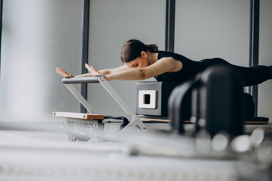 Pilates Reformer Workout Exercises Woman Brunette At Gym Indoor. Stock  Photo, Picture and Royalty Free Image. Image 47935407.