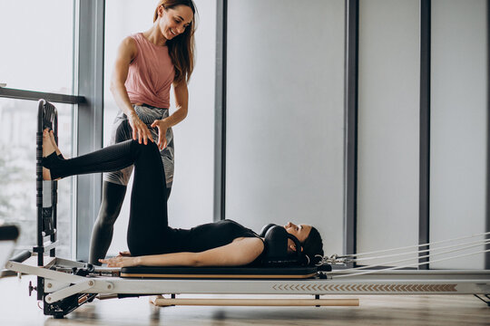 Woman training pilates on the reformer