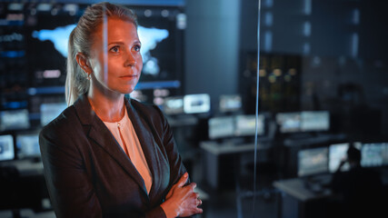 Emotional Female Flight Controller Being Nervous Before a Very Important Space Rocket Launch. Beautiful Portrait with a Reflection in a Mission Control Center. Computer Screens in the Background. © Gorodenkoff