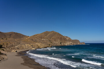 Fototapeta na wymiar Panoramic view of cliffs and beaches in the Gata Cape Natural Park coast near San José. Almería, Andalucía, Spain.