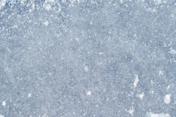 Abstract winter background with lightly snow-covered ice surface