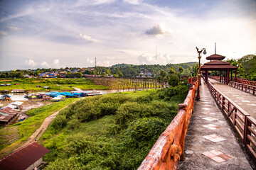 Fototapeta premium Mon Bridge, old wooden bridge at sunset in Sangkhlaburi, Kanchanaburi, Thailand