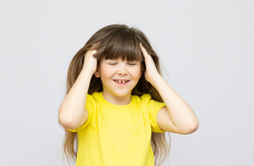 little caucasian girl sit and touch her hair on white background