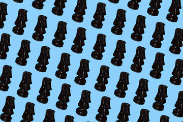 Black, dark knight chess piece multiplied on soft, trendy pastel blue background. Minimal games and recreation concept.