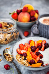 Healthy breakfast with granola, yogurt, fresh berries and coffee