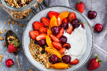 Healthy breakfast with granola, yogurt, fresh berries and coffee