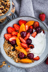 Healthy breakfast with granola, yogurt, fresh berries and coffee