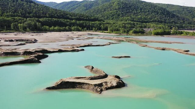 Drone view of the turquoise lake formed as a result of mining waste