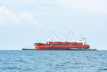 Large ship red color with big crane in the ocean landscape,Industrial boat in the sea logistic concept