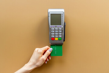 Hand swiping credit card by pos terminal. Payment transactions concept