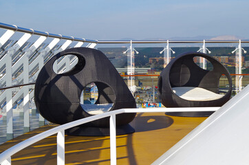 Outdoor sun or pool deck with chairs, loungers and other seating of modern MSC cruiseship cruise...