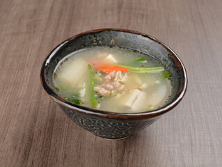 Thai tomyum seafood meat hot soup with spicy chilli sauce on wood table asian halal menu