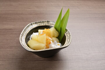 cold Tapioca with fresh coconut milk cream sauce dessert in bowl on wood table asian halal menu