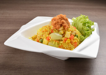 Thai golden pineapple wok fried rice with chicken floss on wood table asian halal menu