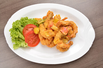 wok fried tiger prawn in salted egg yolk curry paste sauce on wood table asian halal menu