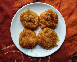 Perkedel kentang or French fries on a white plate