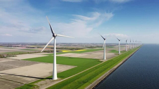 Aerial view on wind turbines on a levee in Flevoland on the IJsselmeer coast in The Netherlands