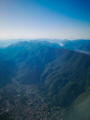 Fototapeta na wymiar Aerial view from plane to cities and mountains in Italy