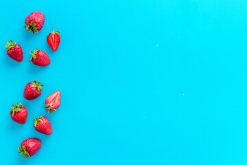 Group of ripe strawberries with green leaves. Flat lay