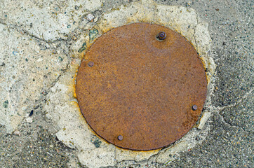 Rusty iron disk with bolts