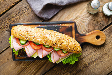 Large sandwich with ham, cheese and vegetables