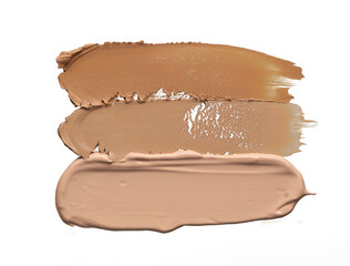 Gently beige strokes and texture of makeup foundation or acrylic paint isolated on white background