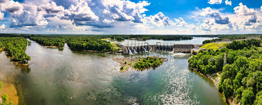 An aerial 180 degree panoramic view of a large dam and hydroelectric plant on the Catawba river in South Carolina and Lake Wylie in the background.