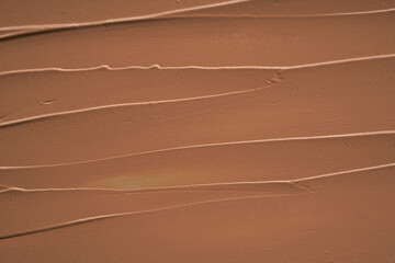 Gently beige strokes and texture of makeup foundation or acrylic paint isolated on white background