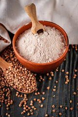 fresh natural buckwheat flour on a dark wooden rustic background culinary concept