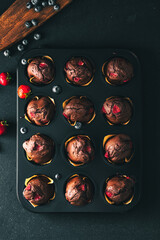Muffin. Chocolate muffins with stawberry. Muffins in cake mold.