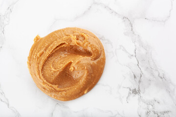peanut butter on white marble background