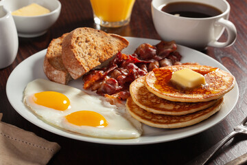 traditional full american breakfast eggs pancakes with bacon and toast