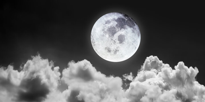 Night scene image of bright and beutiful full moon on dark sky with blurry bright cloudscape for nature and travel transportation background.