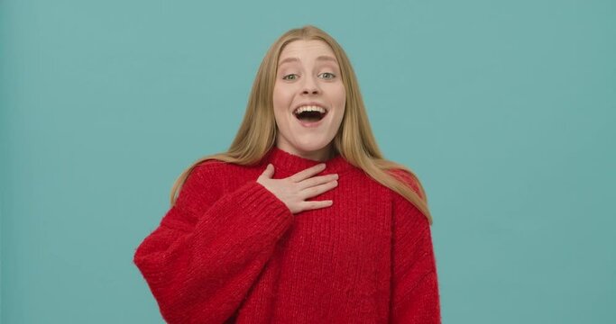 Pretty young woman with long blond hair is surprised and happy to hear pleasant information.
