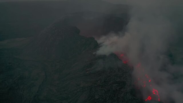 Smoking volcano crater Iceland aerial dim light