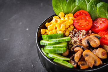 bowl of healthy quinoa with vegetables on a dark rustic background