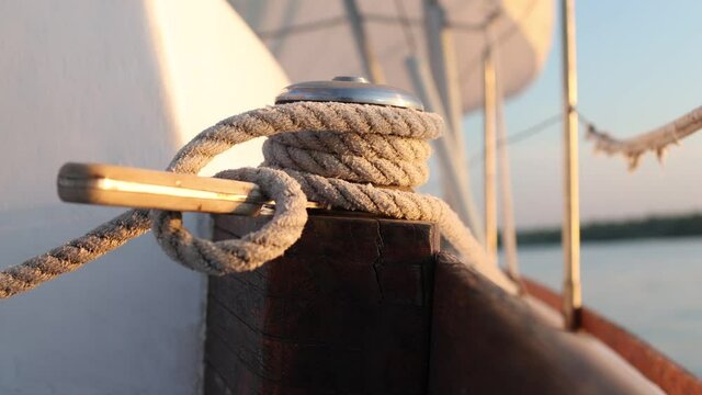 Closeup on yacht cord crank, rope holder on white sail background