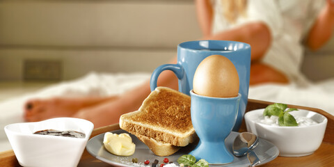 Fresh breakfast in bed and woman body 