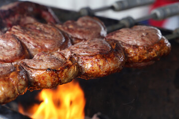 Picanha. Traditional Steak beef in Brazilian barbecue with fire background