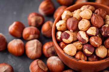 fresh natural hazelnuts on a dark stone background