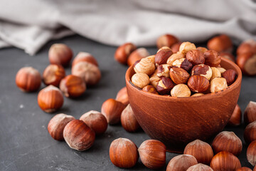 fresh natural hazelnuts on a dark stone background