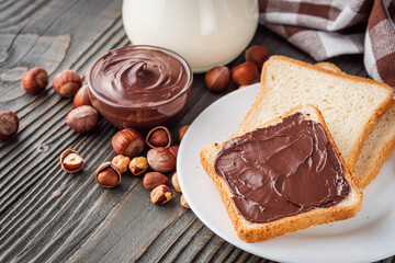 toasts with chocolate butter on a dark wooden rustic background