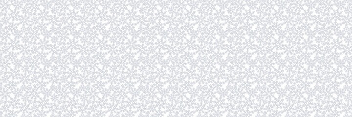 Long rectangular background with snowflakes. Seasonal theme of christmas, winter, snowfall. Gray silvery snow on a white background. Endlessly repeating texture for fabrics, pillows, wrapping paper.