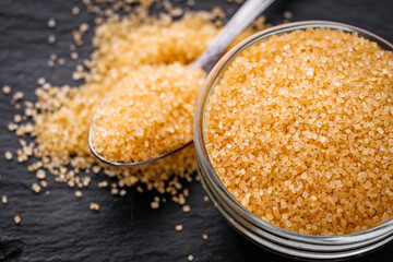 cane brown sugar on a dark stone background