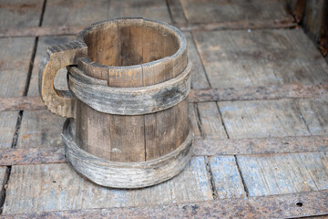 Fototapeta premium old wooden handmade mug on a wooden table