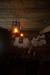 Interior decoration of a traditional Carpathian hut, old fashioned lamp