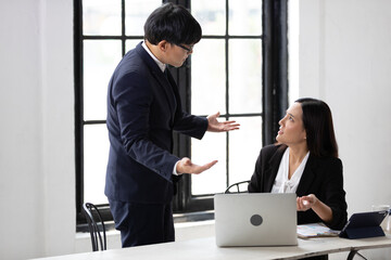 furious two businesspeople arguing strongly after making a mistake at work in office