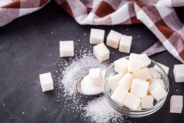 sugar refined on a dark stone background