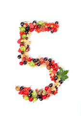 Number five from real natural berries and leaves. Numbers concept made from berries. Summer creative concept.